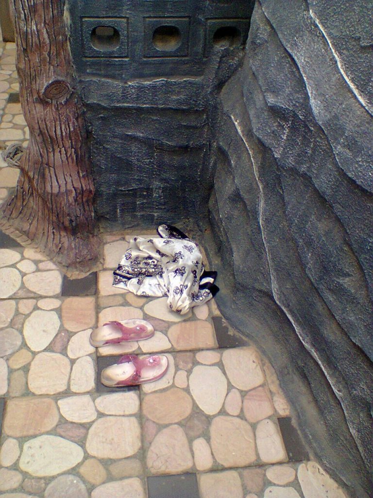 Elorm's sandals and dress by the pool 