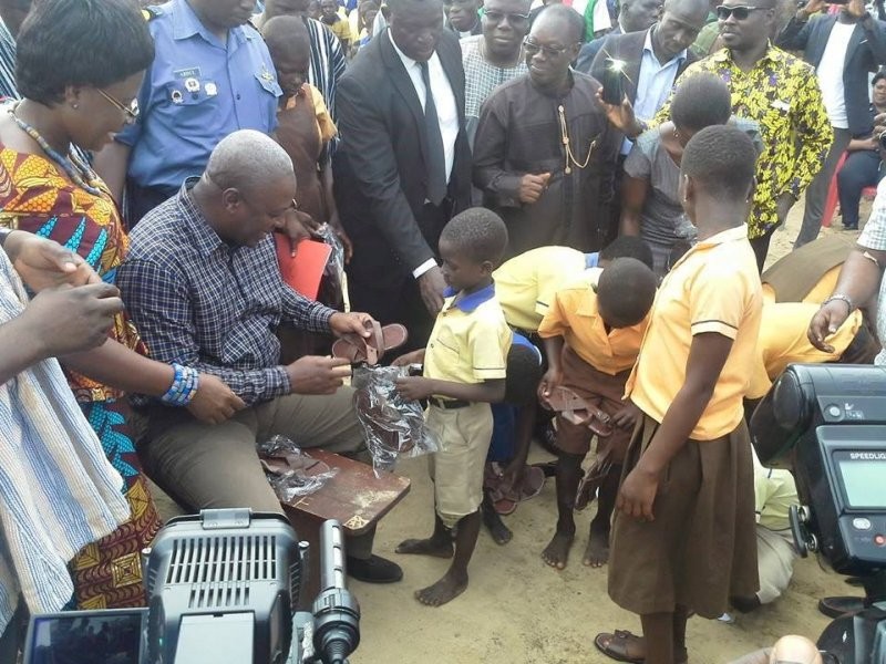 President Mahama poses for a photo opportunity in the name of free school sandals programme. The programme did not continue after this photo opportunity they christened "pilot project"